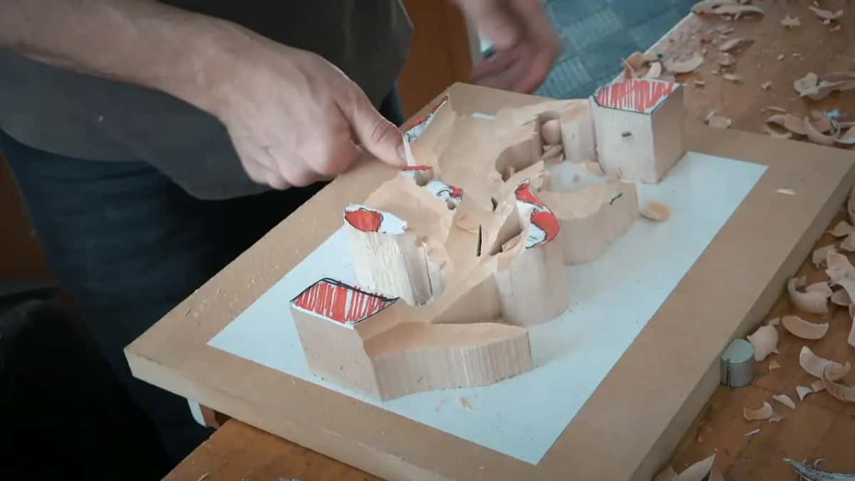 Hollowed middle after the first rough, square orange-topped blocks still tall at the ends, fingers on one edge