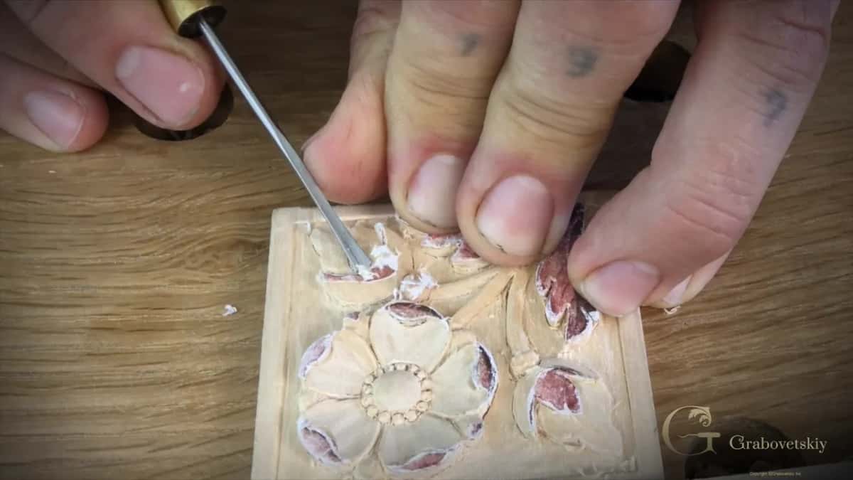 Micro gouge with a brass ferrule lifting white fluff of paper off the top bud