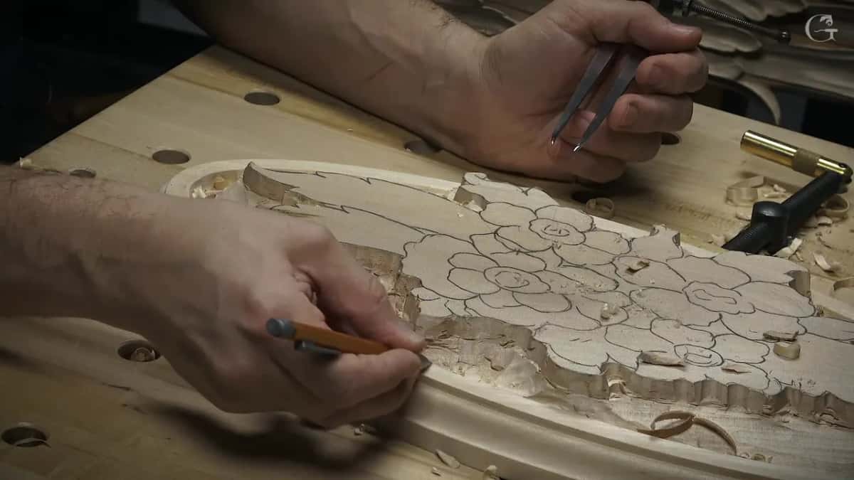 One finger rides the ridge while a pencil marks the molding line, and calipers wait in the other hand