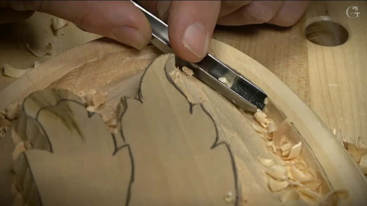 Chips curl out of the inner rim as the gouge works its way round the oval