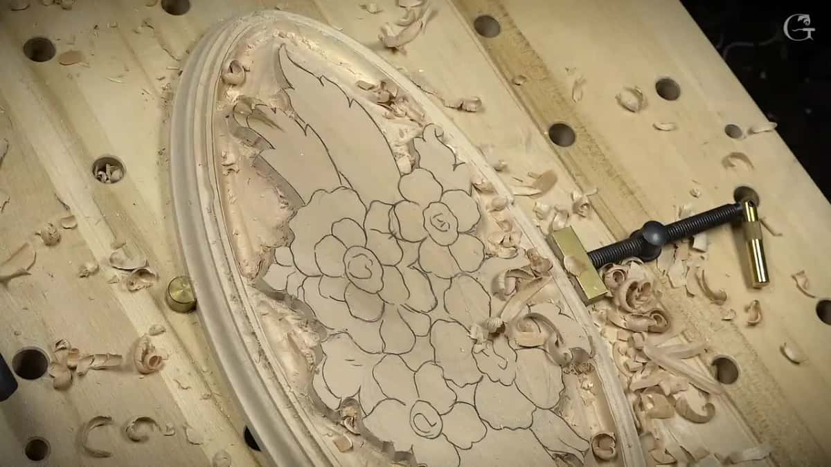 Seen from the end, the routed molding wraps the oval while the roughed bouquet sits inside it