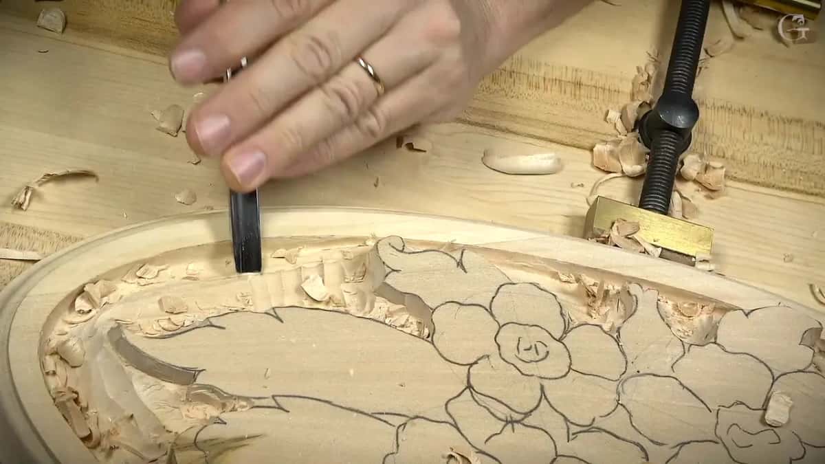 Tool held upright at the edge of the design