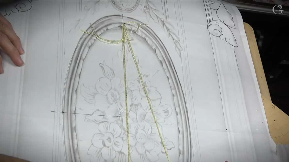 Yellow twine stretched tight over the printed oval drawing
