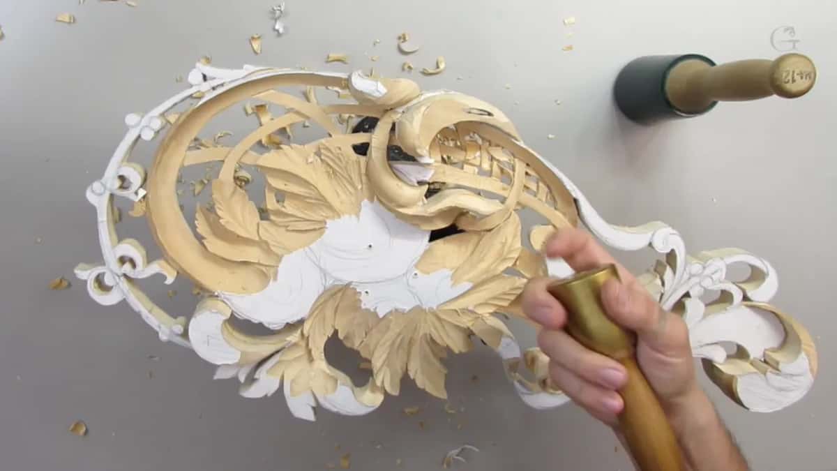 Brass mallet held over the panel, green rubber one lying beyond