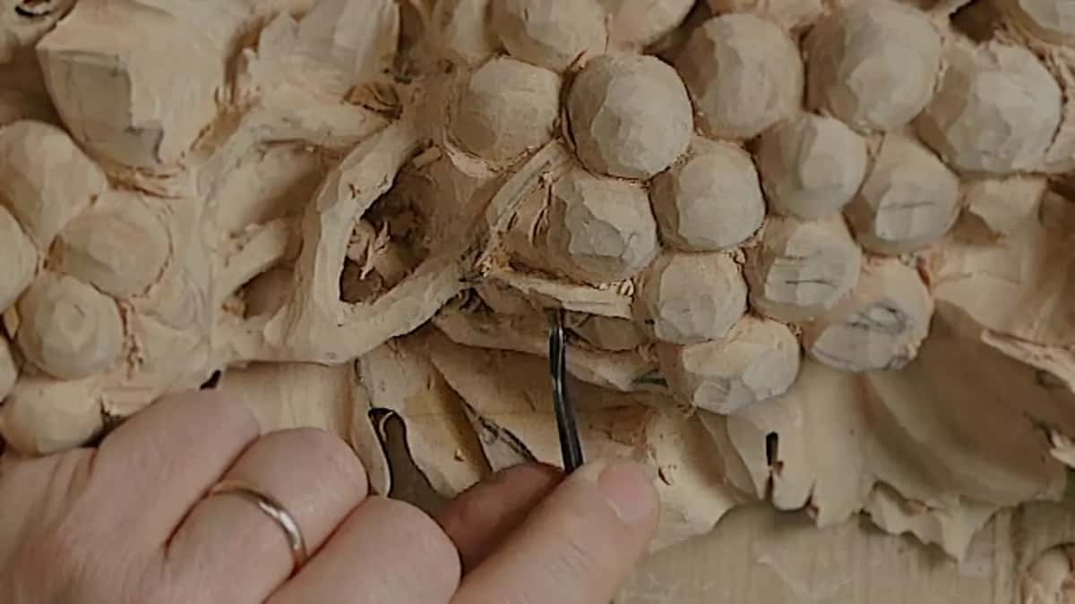 Narrow tool under carved grape clusters