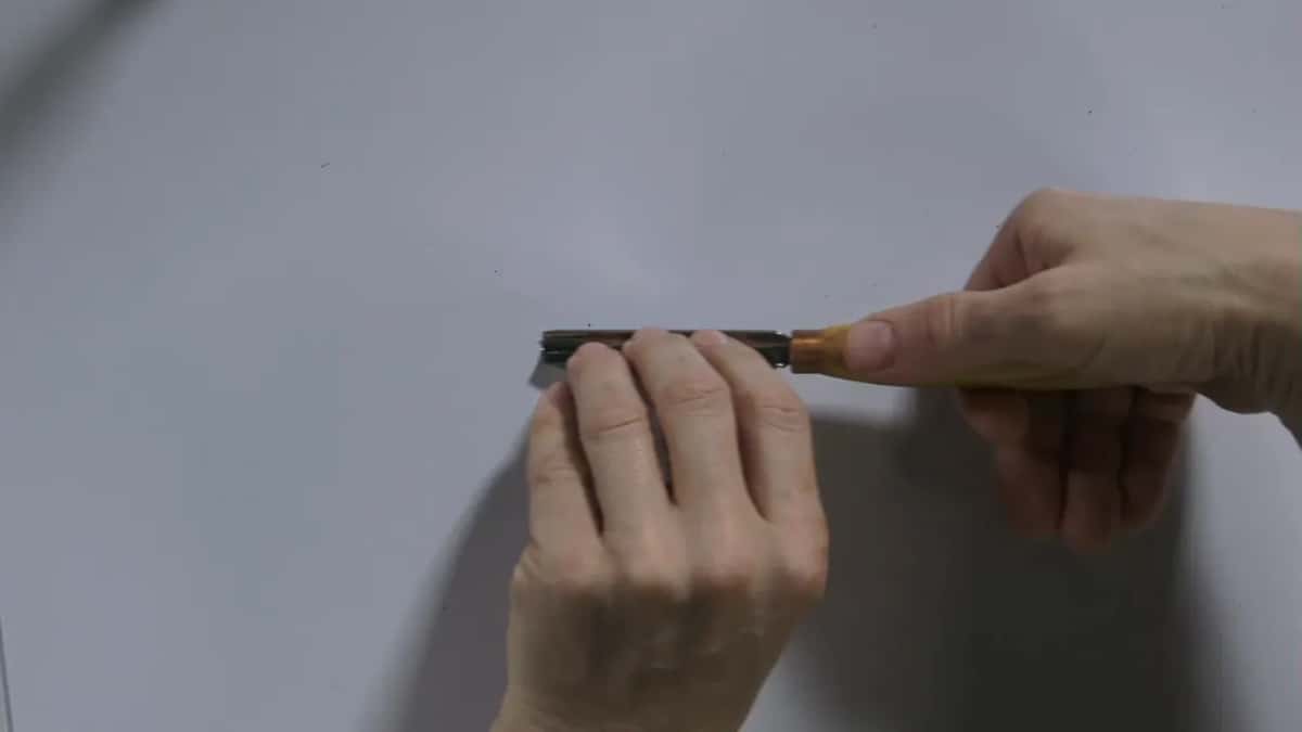 Small tool held level against a white background