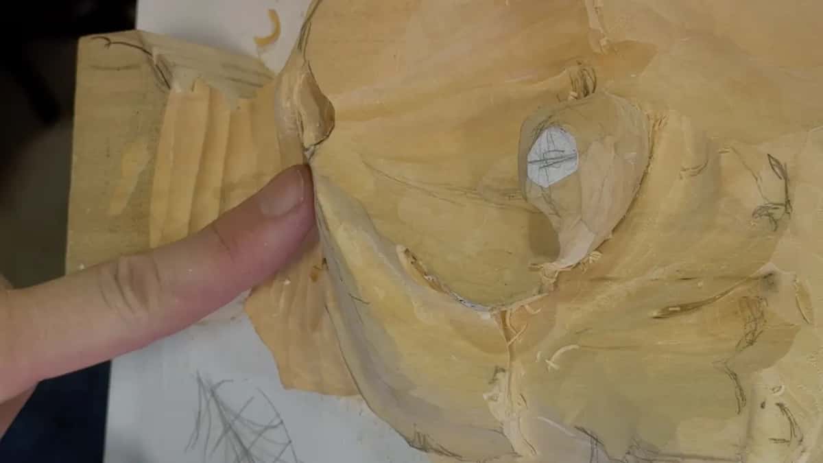 My fingertip on the joint for the class, the grooved block on the left and the drawing on the paper below