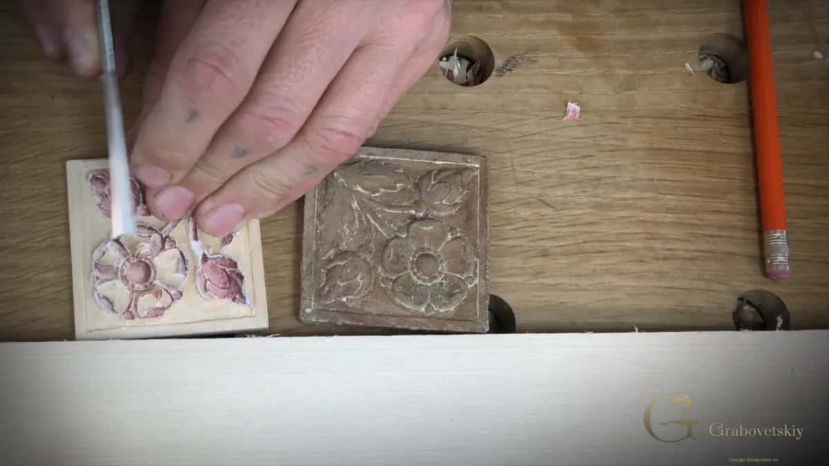 Toward the center Seen from above, a slim white handled gouge works toward the center with the brown original close by