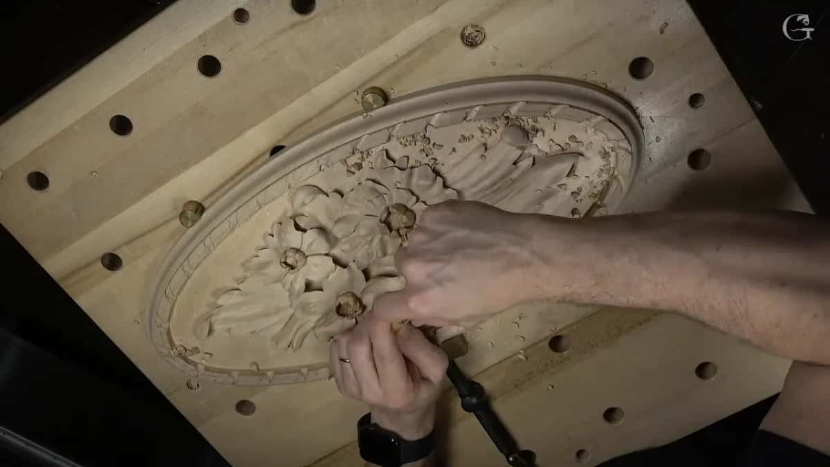 Seen from overhead, both hands work the rim at the lower end of the oval