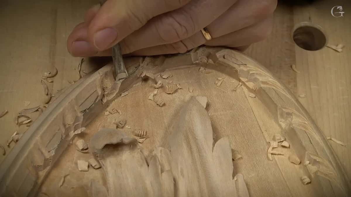 A ringed hand steadies the tool