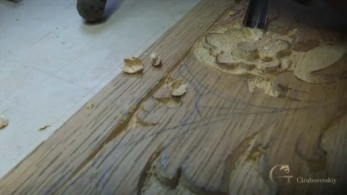 Pencil lines still visible beside a flower sunk into a long board