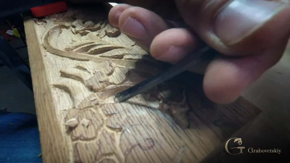 Chips curling off a leaf edge beside the lowered ground