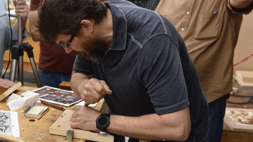 This class is designed to be an introduction to basic carving skills and would be perfect for any furniture maker who wants to take his or her work to the next level. Alexander will introduce the student to the design process and ways to embellish their furniture as well as give it character. He will start by sharing his sharpening techniques which he calls “sharpening on steroids.” This is a production style of sharpening that is fast and precise, which he uses every day that he carves. Demonstrations will also include how to use carving gouges the old fashioned way – by hand. This class will cover tool selection, how to work with grain issues in the wood, planning the cut, ways to carve safely, how to clamp the wood without damaging the carving, and subtle tips and tricks in getting the best use out of your gouges. Students will start with carving a basic relief of a floral decoration, then move on to a more advanced relief carving of a classical acanthus leaf design, and finally will move on to carve a classic shell design in relief. Alexander will explain how to think through a carving project in order to make the carving process the most efficient. He will also demonstrate how to carve the linen-fold design, how to carve grapes or beads, and how to carve lettering. Key Points: *Sharpening gouges *How to properly hold gouges for safety & efficiency *How to lower down background for relief carving *How to work with wood grain issues *How to carve a basic floral decoration *How to carve a more advanced classical acanthus leaf decoration *How to carve a classical scallop shell carving *Tips and tricks on how to get the most out of your gouges *Demonstrations on linen-fold design, grapes, and letter carving