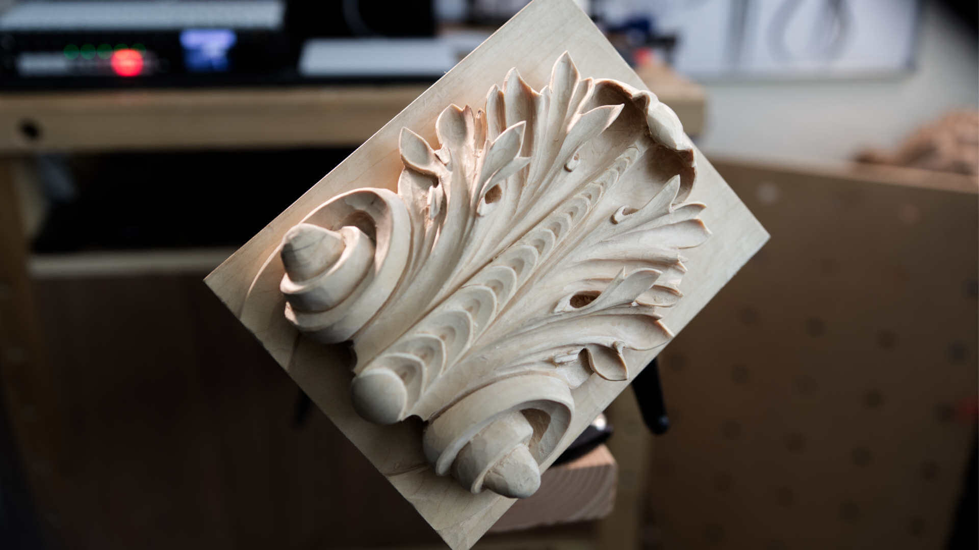 A beautifully carved decorative wood piece showcasing intricate leaf patterns and curvatures. This masterful work shines with craftsmanship, perfect for inspiration in wood carving classes or lessons.