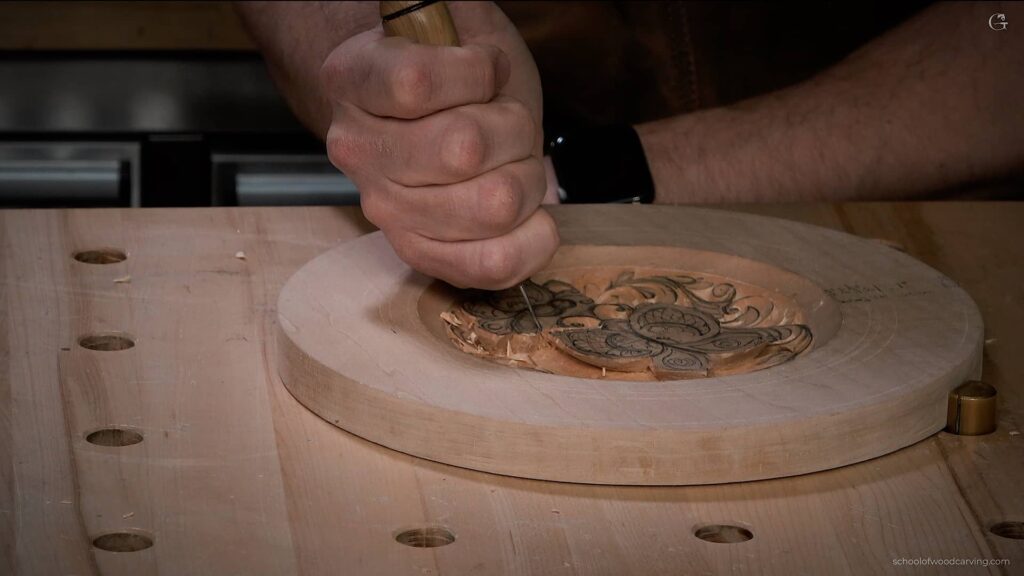 Close-up of a hand carving an intricate design into a round wooden piece, ideal for wood carving tutorials for beginners.